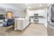 Open-concept kitchen featuring white cabinets and stainless steel appliances at 5317 Pagnotta Pl, Lutz, FL 33558