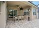 Covered outdoor patio with brick flooring, patio table, chairs, and a ceiling fan at 5317 Pagnotta Pl, Lutz, FL 33558