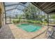 Relax in style with this screened-in pool and spa, surrounded by beautiful landscaping and a brick deck at 5317 Pagnotta Pl, Lutz, FL 33558