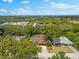 Aerial view showcasing a residential neighborhood with a view of the Gulf and mature trees at 535 Sandy Hook, Palm Harbor, FL 34683