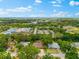 Wide aerial view of the neighborhood, highlighting mature trees, and proximity to local amenities at 535 Sandy Hook, Palm Harbor, FL 34683