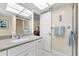 Bright bathroom with white cabinets, a large mirror, and tiled floors at 535 Sandy Hook, Palm Harbor, FL 34683