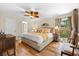 Comfortable bedroom with stylish ceiling fan, wood floors, and ample natural light at 535 Sandy Hook, Palm Harbor, FL 34683