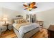 Bright bedroom with neutral tones, wood floors, and a decorative ceiling fan at 535 Sandy Hook, Palm Harbor, FL 34683