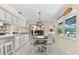 Charming dining area with backyard view and white chairs next to the kitchen at 535 Sandy Hook, Palm Harbor, FL 34683