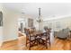 Elegant dining room featuring a chandelier and seamless access to the living area and outdoor views at 535 Sandy Hook, Palm Harbor, FL 34683