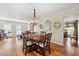 Chic dining room featuring chandelier lighting and seamless access to the living area and outdoor views at 535 Sandy Hook, Palm Harbor, FL 34683
