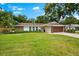Charming one-story home featuring stone accents, a manicured lawn, and a two-car garage at 535 Sandy Hook, Palm Harbor, FL 34683