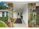 Covered entry featuring stone columns and stylish double doors, creating a welcoming entrance to the home at 535 Sandy Hook, Palm Harbor, FL 34683