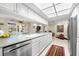 Bright, open kitchen with view of living room and dining area, featuring stainless steel dishwasher at 535 Sandy Hook, Palm Harbor, FL 34683