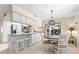 Bright kitchen featuring white cabinetry, stainless steel appliances, and a cozy dining nook at 535 Sandy Hook, Palm Harbor, FL 34683