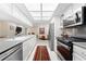 Spacious kitchen featuring white cabinetry and stainless steel appliances with a view to the living room at 535 Sandy Hook, Palm Harbor, FL 34683