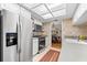 Close up of the Kitchen with white cabinets, tiled backsplash and stainless steel appliances at 535 Sandy Hook, Palm Harbor, FL 34683