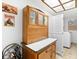 Charming laundry area featuring an antique hutch, posters, folding screen, and modern washer and dryer at 535 Sandy Hook, Palm Harbor, FL 34683
