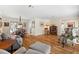 Open-concept living room with hardwood floors, dining area, and comfortable seating arrangement at 535 Sandy Hook, Palm Harbor, FL 34683