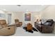 Comfortable living room with leather furnishings, decorative rug, and neutral tones at 535 Sandy Hook, Palm Harbor, FL 34683