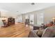 Bright living room with hardwood floors, large windows with blinds, and cozy seating at 535 Sandy Hook, Palm Harbor, FL 34683
