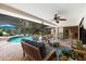 Spacious screened patio with comfortable lounge seating, ceiling fan, and seamless indoor-outdoor living at 535 Sandy Hook, Palm Harbor, FL 34683