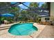 Inviting screened-in pool with a patio area ideal for entertaining and enjoying the outdoors at 535 Sandy Hook, Palm Harbor, FL 34683
