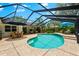 Relaxing screened-in pool with a spacious deck, perfect for outdoor gatherings and leisure at 535 Sandy Hook, Palm Harbor, FL 34683
