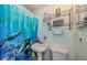 Bathroom with unique vanity and decorative blue shower curtain at 6111 2Nd Ave, New Port Richey, FL 34653