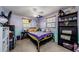 Bedroom with a ceiling fan, two windows, and built-in black shelving for storage at 6111 2Nd Ave, New Port Richey, FL 34653