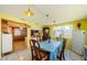 Cozy dining area with bright yellow walls and a view into the kitchen at 6111 2Nd Ave, New Port Richey, FL 34653