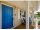 Inviting front porch with a bright blue door and comfortable seating area at 6111 2Nd Ave, New Port Richey, FL 34653