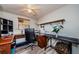 Home office with two workstations, shelving, and light wood flooring at 6111 2Nd Ave, New Port Richey, FL 34653