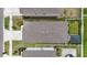 Aerial view of the home's roof, driveway, and surrounding yard with privacy fence at 7225 Ronnie Gardens Ct, Tampa, FL 33619