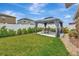 Backyard featuring a covered gazebo with seating and a green lawn space at 7225 Ronnie Gardens Ct, Tampa, FL 33619