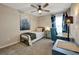 Bedroom featuring modern fixtures, blue accents, and a desk area by the window at 7225 Ronnie Gardens Ct, Tampa, FL 33619