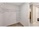 Well-organized closet with wire shelving, leading to a bathroom with a shower, efficient and functional design at 7225 Ronnie Gardens Ct, Tampa, FL 33619