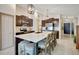 Spacious kitchen with a large island, seating, stainless appliances, and dark cabinets at 7225 Ronnie Gardens Ct, Tampa, FL 33619