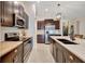 Modern kitchen featuring stainless steel appliances, dark cabinetry, and a center island with bar seating at 7225 Ronnie Gardens Ct, Tampa, FL 33619