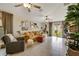 Cozy living room with comfortable seating, plants, and a sliding glass door, creating a relaxing atmosphere at 7225 Ronnie Gardens Ct, Tampa, FL 33619
