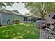 Green backyard with artificial grass, above-ground pool, screened porch, and mature trees at 759 Cape Cod Cir, Valrico, FL 33594