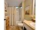 Bright bathroom featuring a shower-tub combination, and unique storage for towels and wine at 759 Cape Cod Cir, Valrico, FL 33594