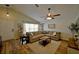 Cozy living room with a comfortable sectional couch, a ceiling fan, and natural light at 759 Cape Cod Cir, Valrico, FL 33594