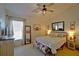 Comfortable main bedroom features a stylish ceiling fan, large windows, and thoughtfully chosen decor creating a peaceful retreat at 759 Cape Cod Cir, Valrico, FL 33594