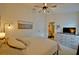 Serene main bedroom showcases a ceiling fan, dresser, and soft lighting, creating a relaxing and inviting atmosphere at 759 Cape Cod Cir, Valrico, FL 33594