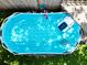 Aerial view capturing the pool's crystal-clear water and surrounding landscaping at 759 Cape Cod Cir, Valrico, FL 33594