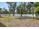 Large backyard with vinyl fencing, lush mature trees, and a patio area for outdoor entertaining at 770 27Th S Ave, St Petersburg, FL 33705