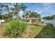 Wide backyard with mature trees, grass, and privacy fence at 770 27Th S Ave, St Petersburg, FL 33705