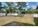 Expansive backyard featuring a mature tree, a white fence and privacy landscaping at 770 27Th S Ave, St Petersburg, FL 33705