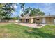 A backyard is made up of a brick patio, a green lawn, and a white fence at 770 27Th S Ave, St Petersburg, FL 33705