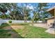 Large backyard with privacy fence, mature trees, grassy area, and brick patio at 770 27Th S Ave, St Petersburg, FL 33705