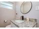 Bathroom vanity features granite counters, modern black fixtures, and a round mirror at 770 27Th S Ave, St Petersburg, FL 33705