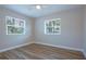 Empty bedroom features hardwood floors, two windows, and ceiling fan at 770 27Th S Ave, St Petersburg, FL 33705