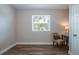 Bright bedroom with wood-look floors, a window, and a small side table setup at 770 27Th S Ave, St Petersburg, FL 33705